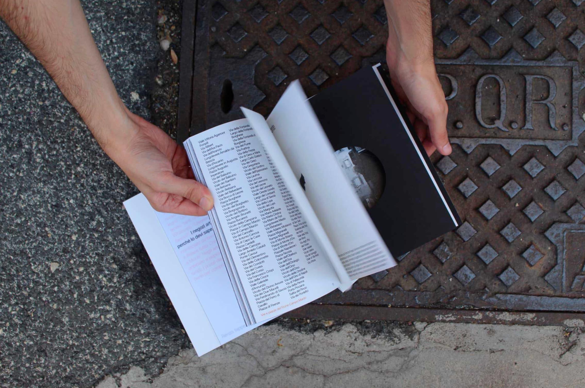Open Stato in Luogo book showing a list of place names beside a black page with a circular photograph.