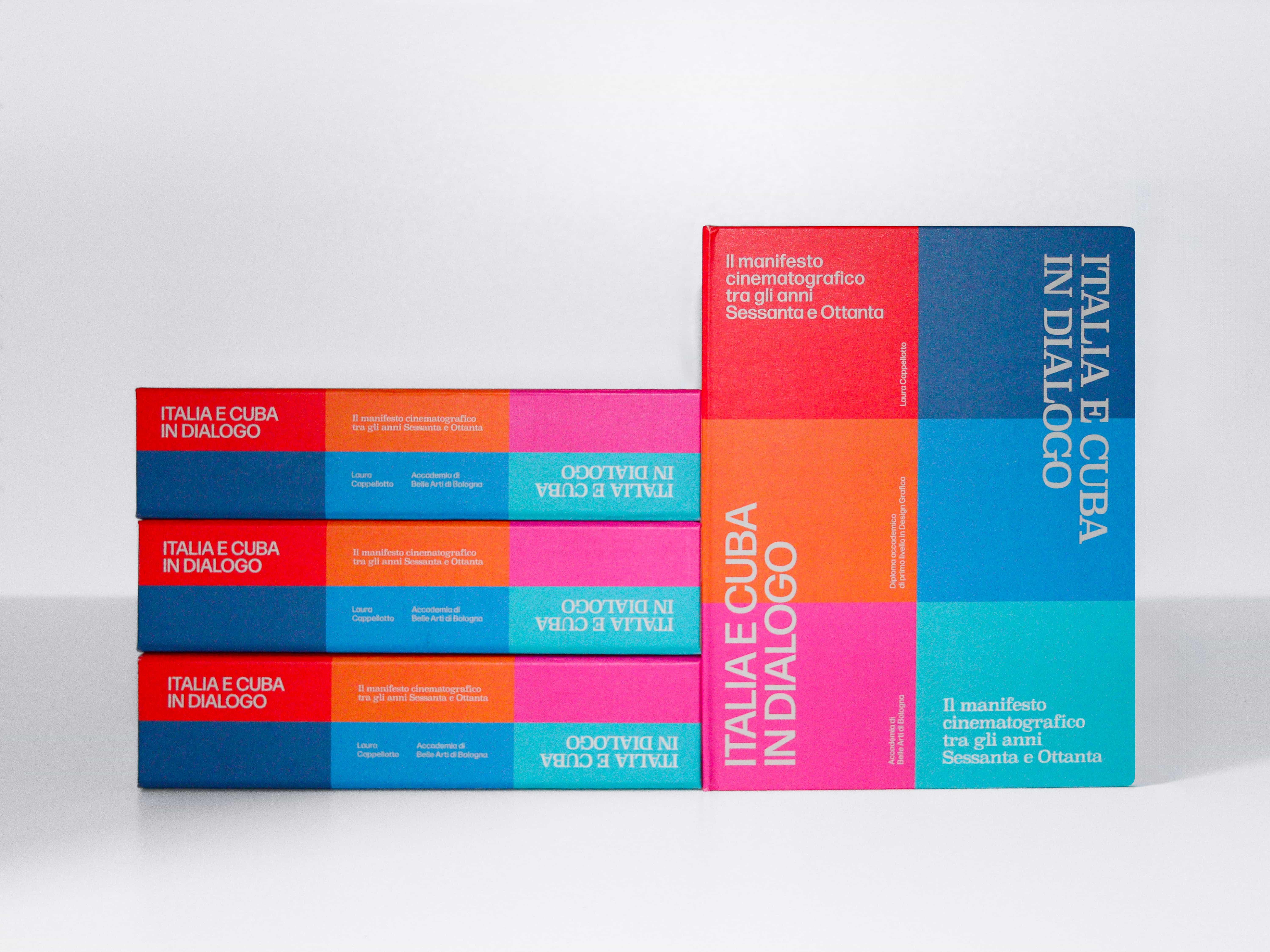 Copies of Italia e Cuba in dialogo stacked flat beside one standing upright with its colour-blocked cover facing out.