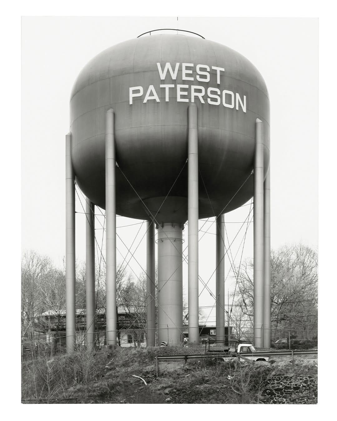 Black-and-white photograph of the West Paterson water tank, a reference for Zetal's lettering.