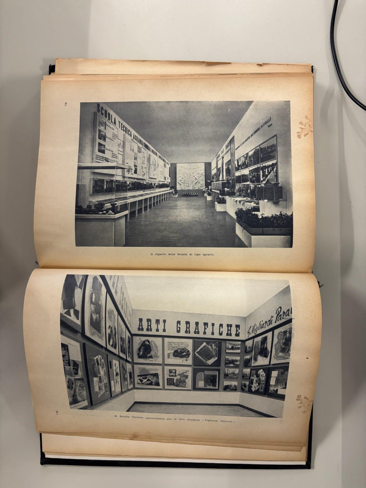 Open book with black-and-white photographs of an exhibition display.
