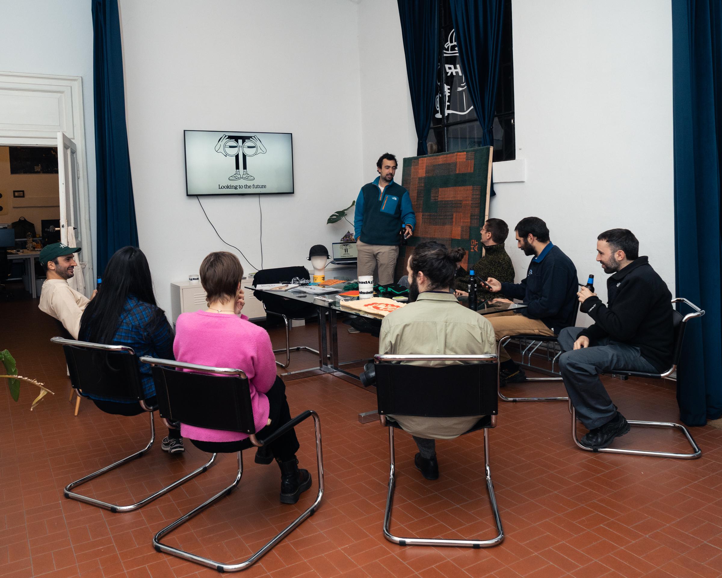 Attendees watching a presentation in the Firm studio.