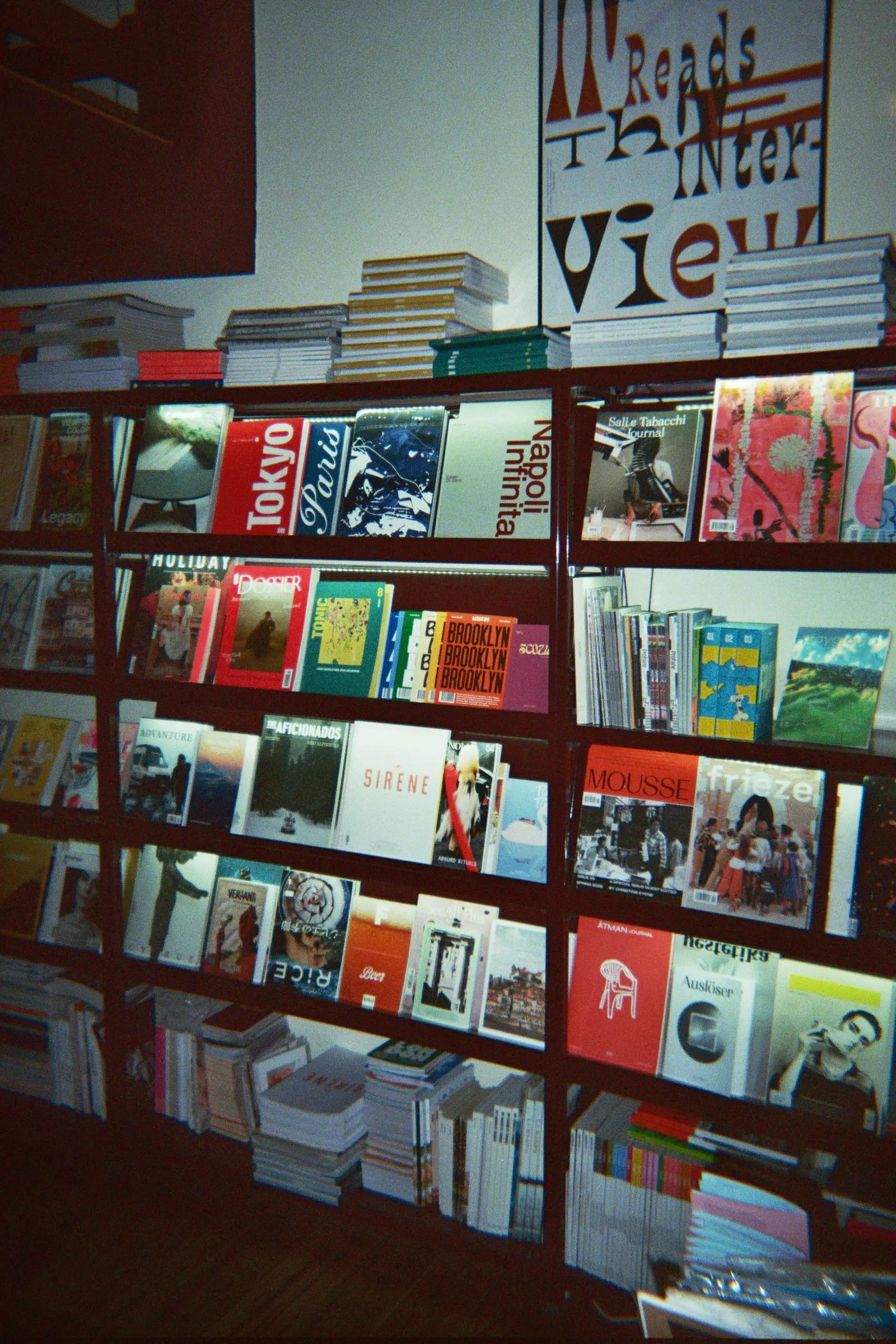 Magazine display beneath a poster reading "Readers see things".
