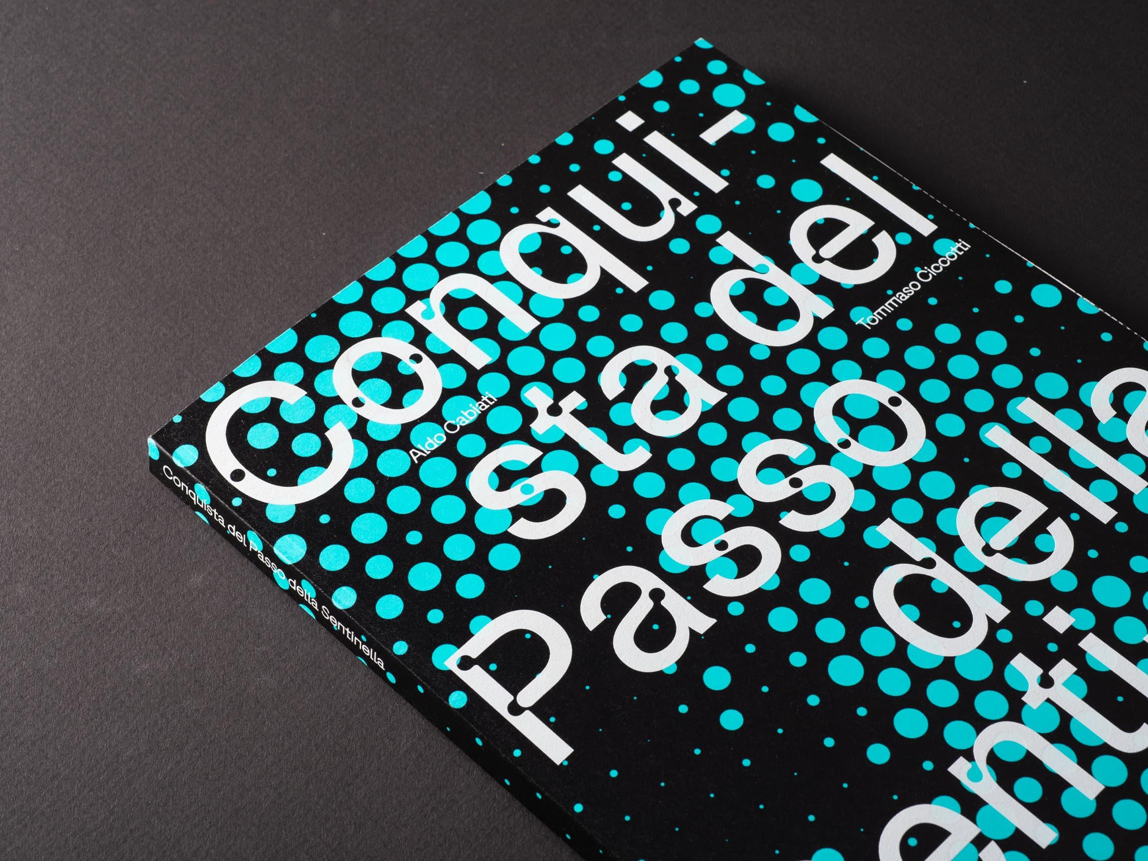 Turquoise dotted booklet with large white lettering on a black background.