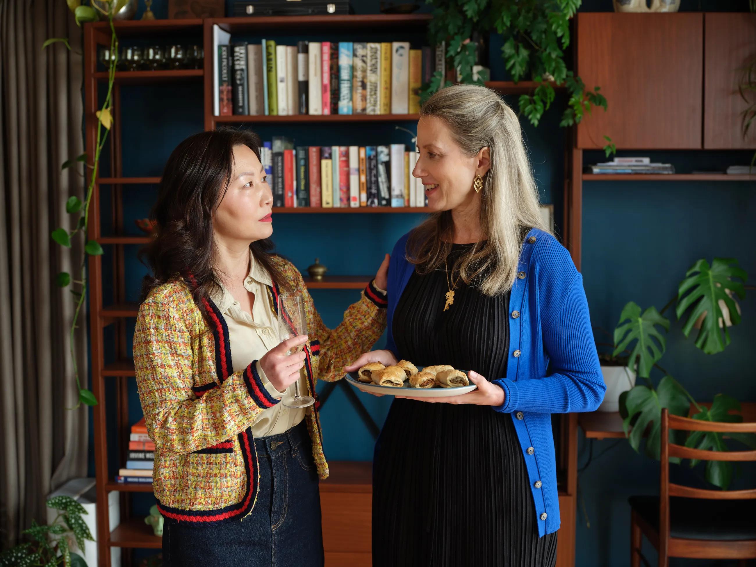 Two ladies at a dinner party conversing