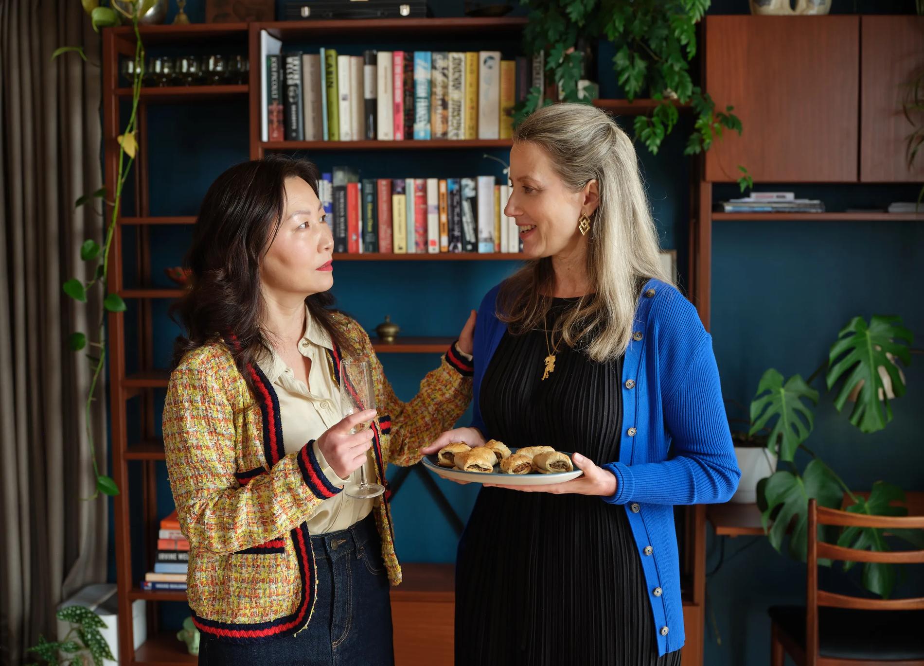 Two ladies at a dinner party conversing