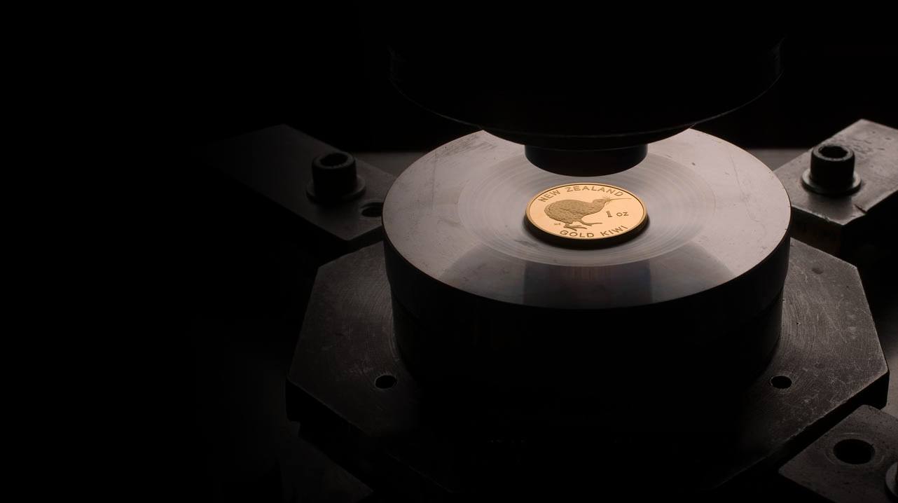 A gold 1oz coin with a "New Zealand Gold Kiwi" label