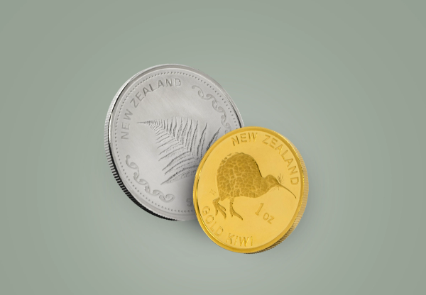 Two coins are shown: a large silver one with a fern and "New Zealand," and a smaller gold one with a kiwi bird and "1 oz Gold Kiwi."