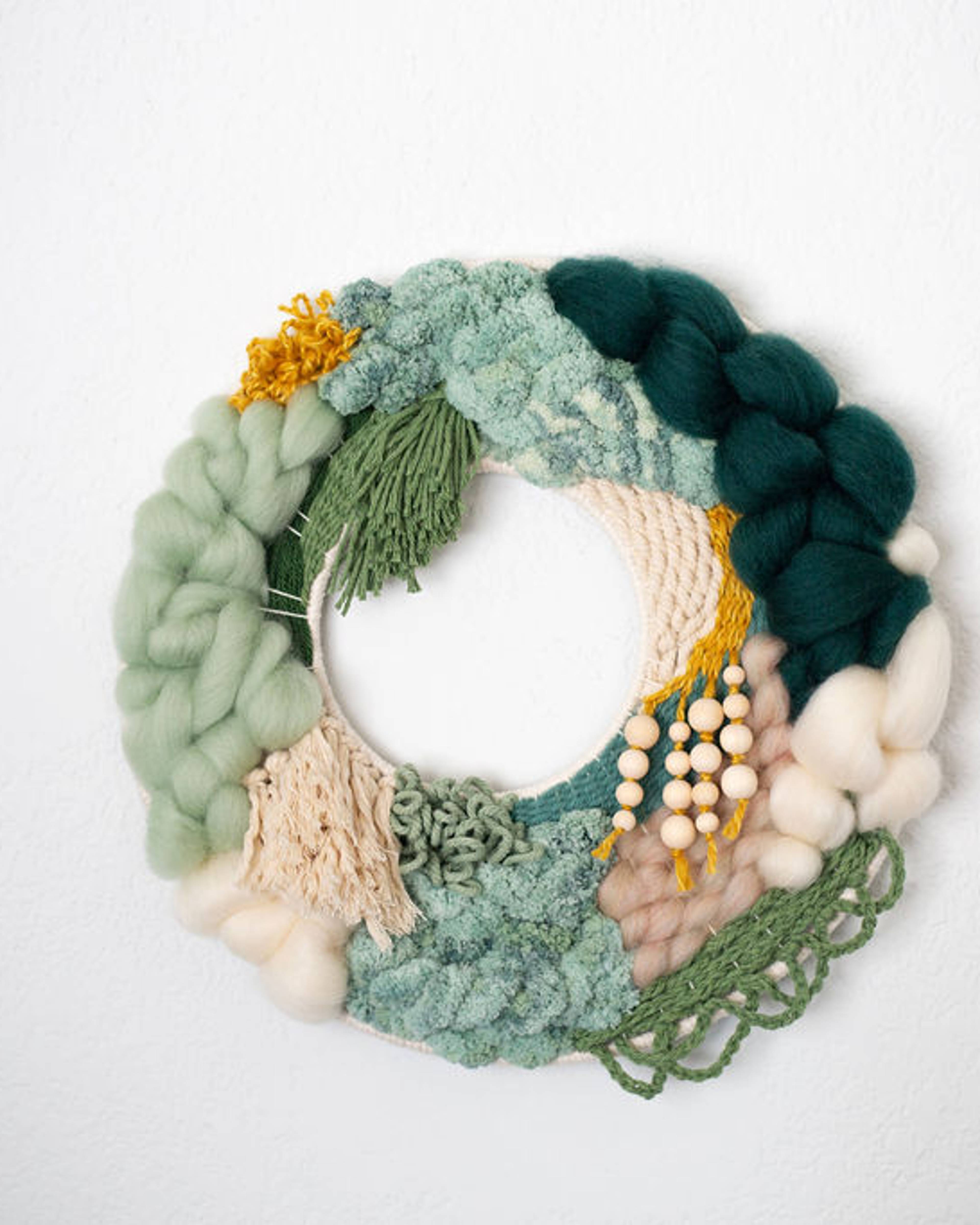 Round fiber wreath in sage, deep green and cream with beaded accents