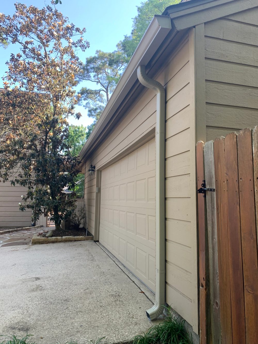 Clay seamless gutter and downspout on the wood-sided detached garage in The Woodlands