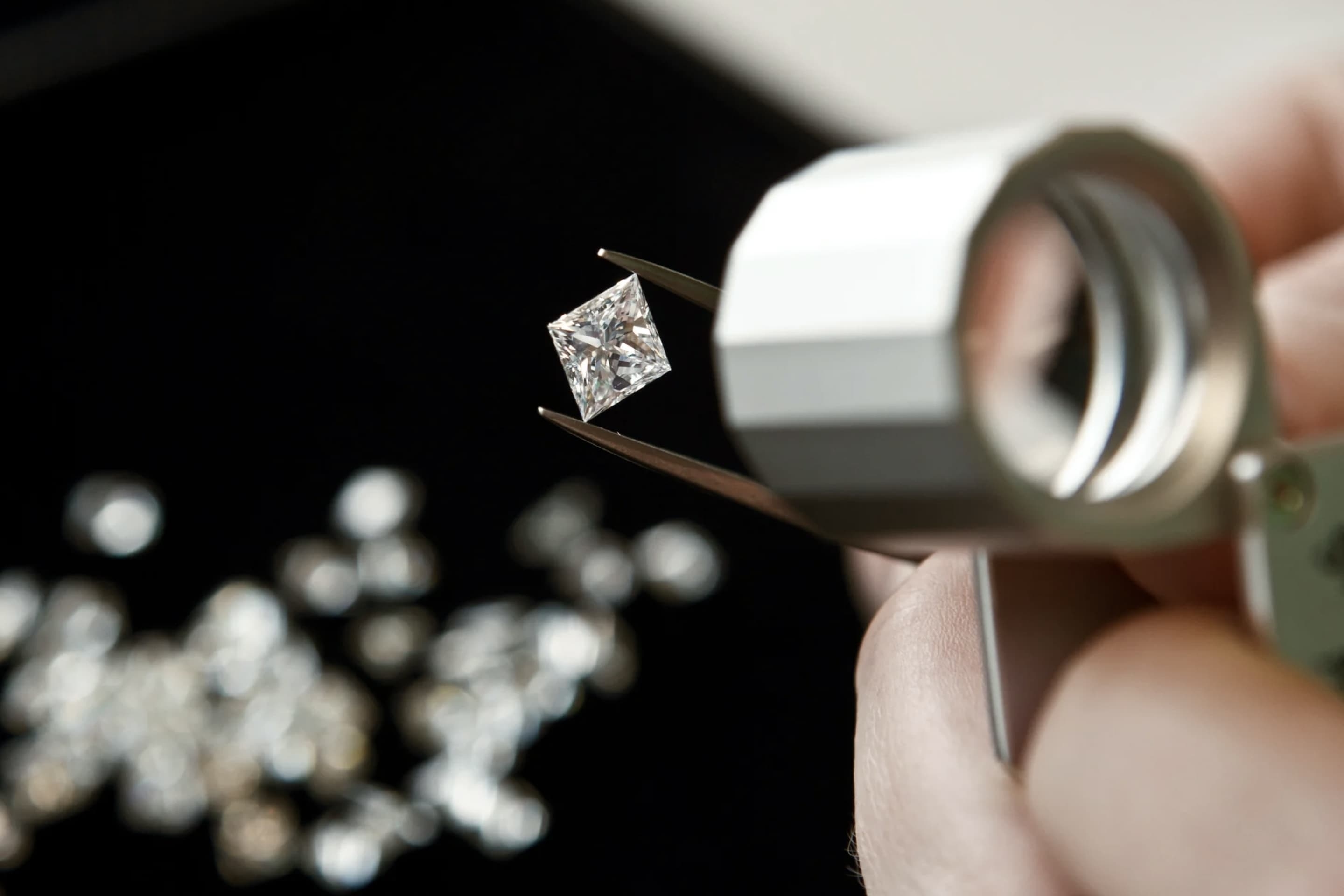 Diamond jeweler inspecting stones with a magnifying glass