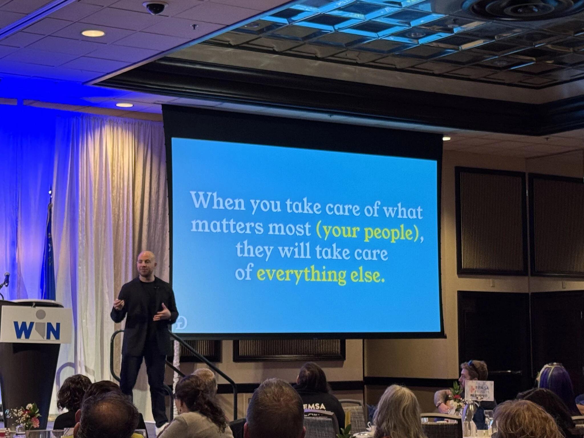 Danny Goldberg speaking on stage with a presentation slide