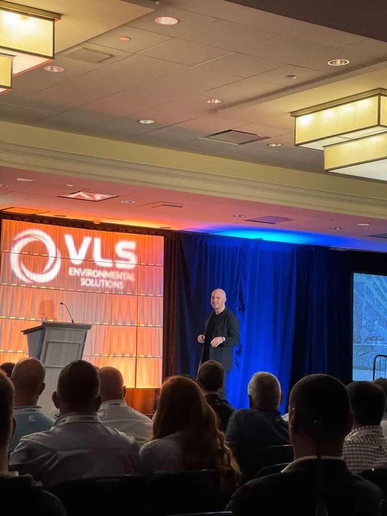 Danny Goldberg speaking on stage at a VLS Environmental Solutions event