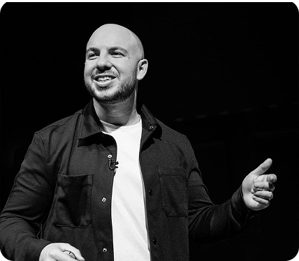 Danny Goldberg speaking on stage, black and white photo