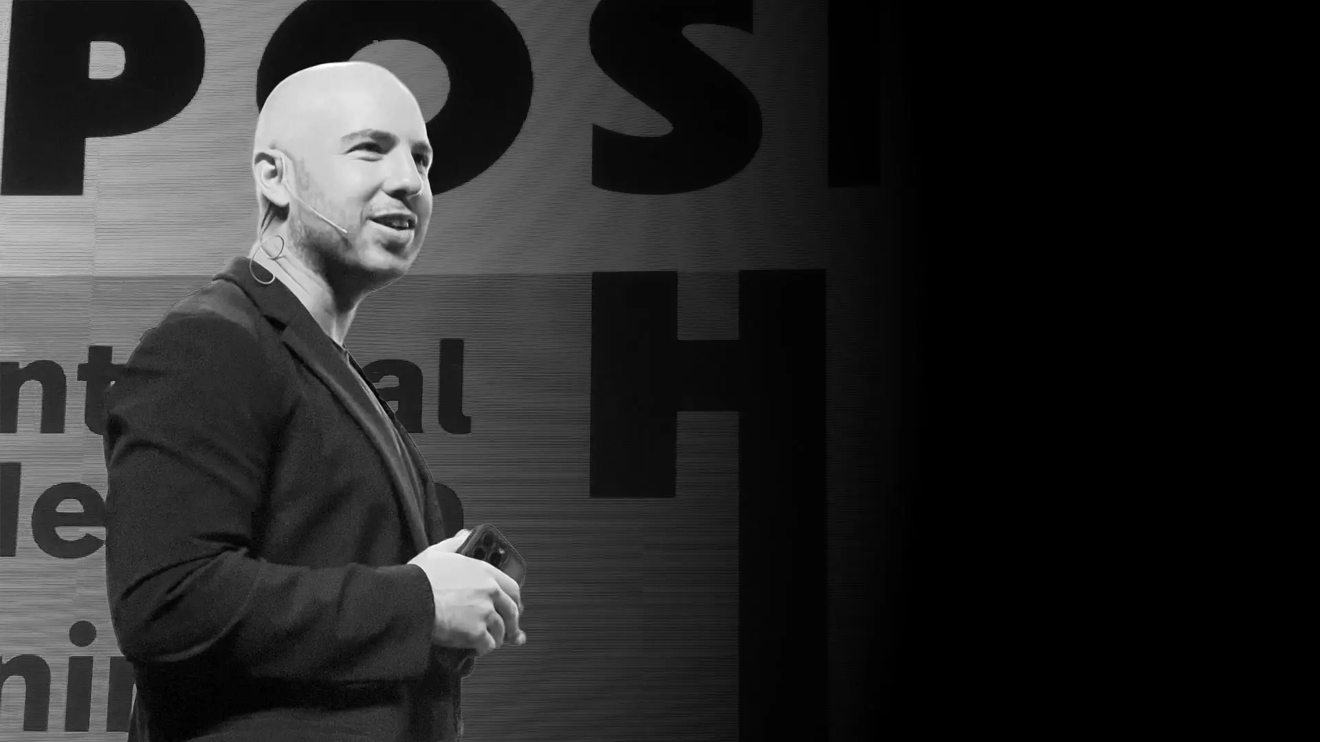Danny Goldberg speaking on stage, wearing a headset microphone