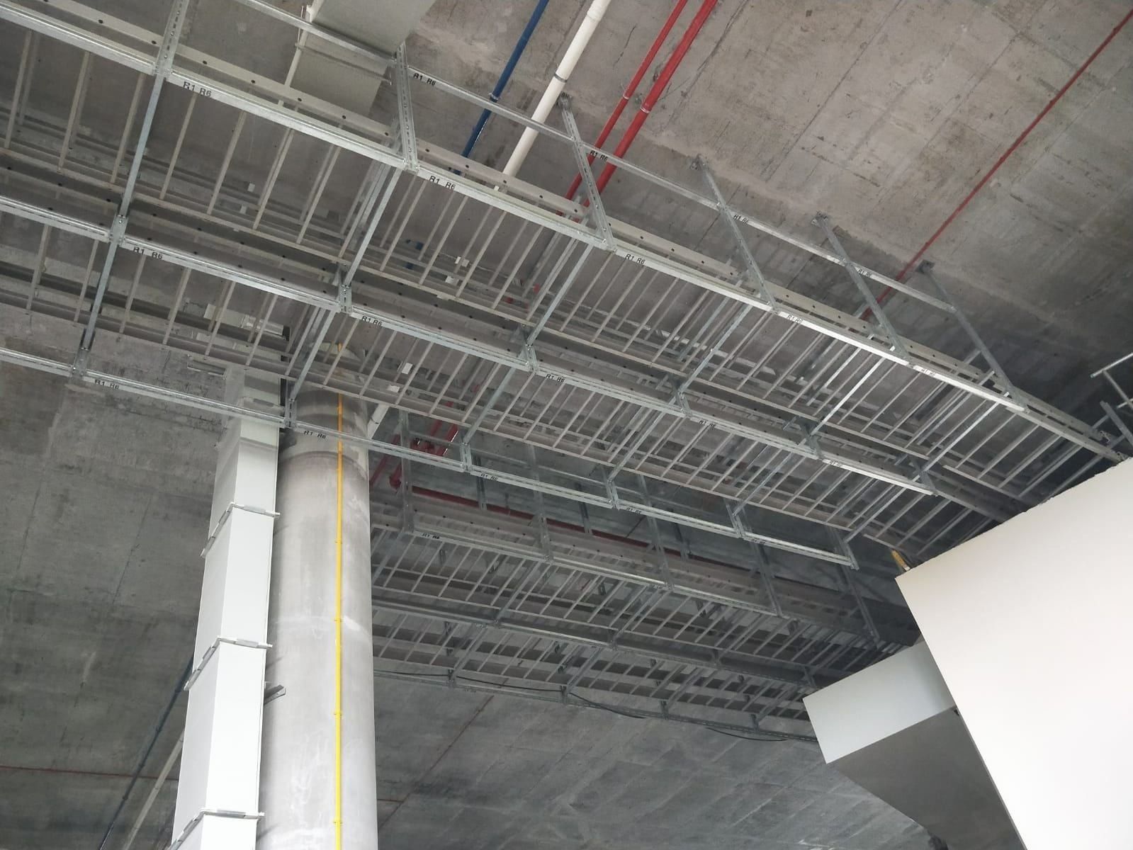 Tiers of galvanised cable ladder hung from the ceiling slab on channel supports