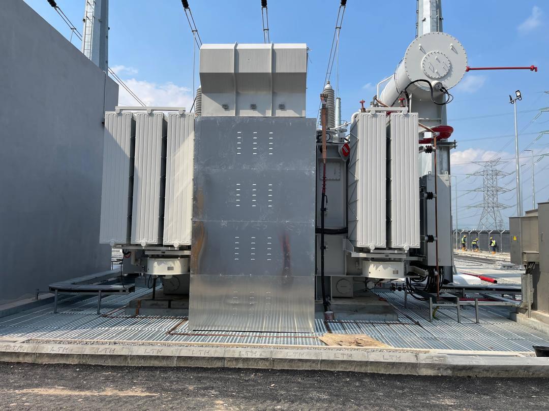 Aluminium sunshield panels in front of the transformer tank, on a grating floor