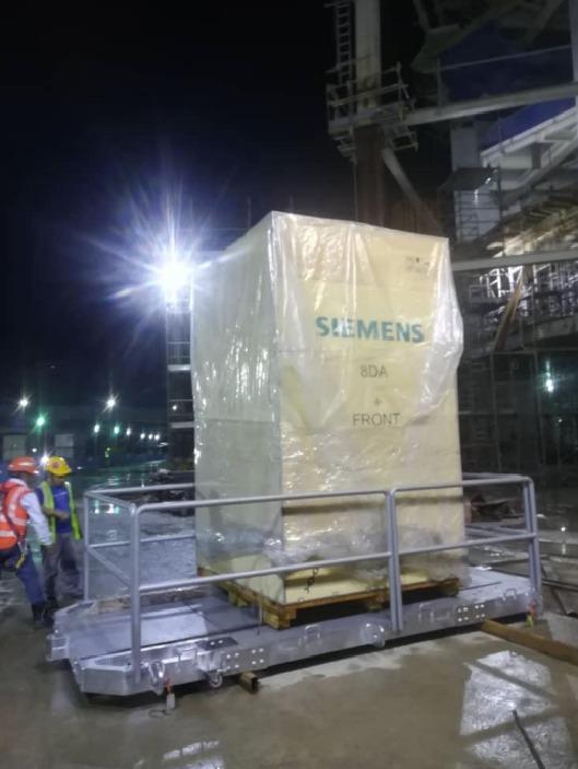 Siemens switchgear crate loaded on the lifting platform on site at night