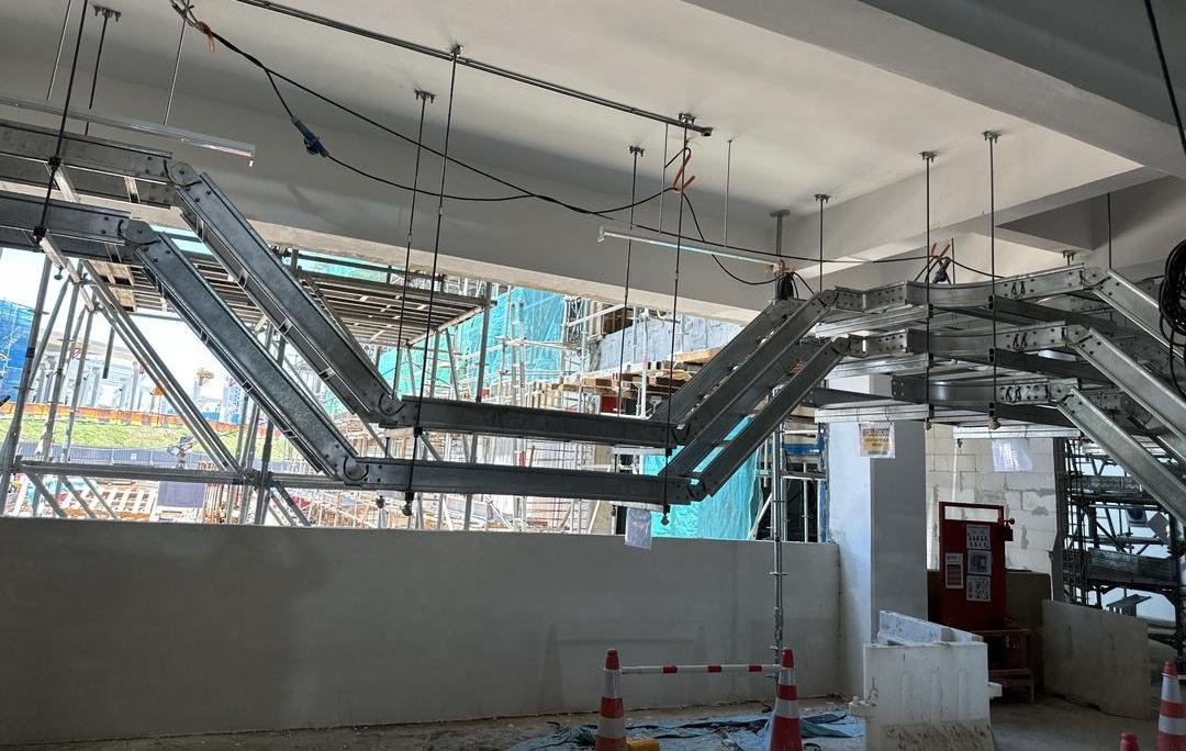 Cable ladder risers and bends hung from the slab on threaded rod