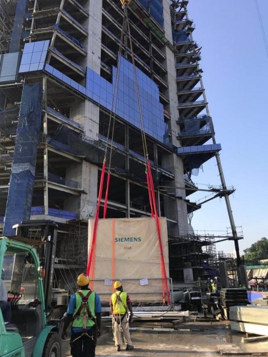 Crated Siemens switchgear on the platform being lifted up the PNB 118 tower