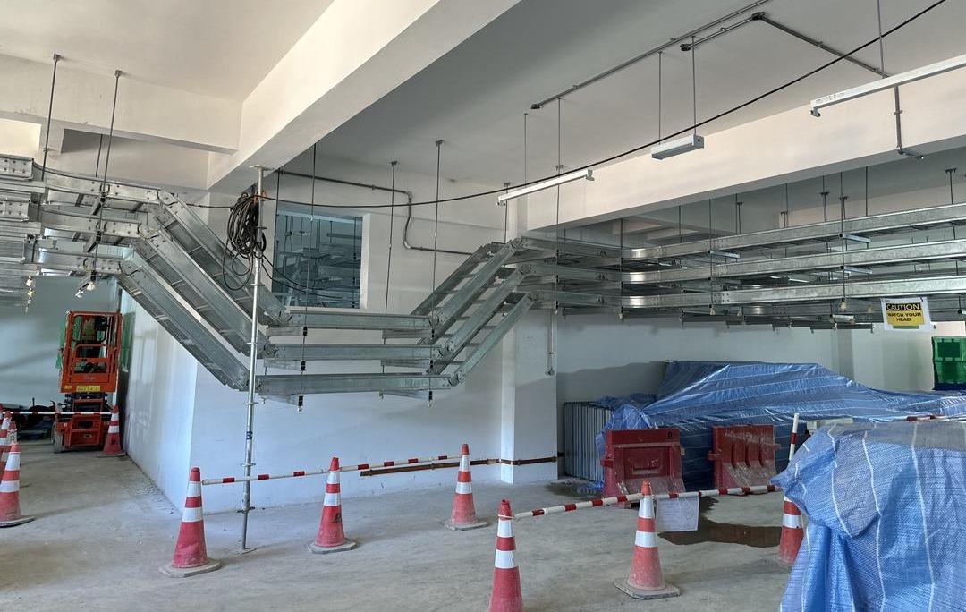 Cable ladder runs stepping down a wall on vertical bends