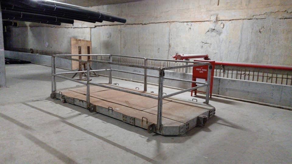 Lifting platform with guard rails standing in a plant room inside the tower