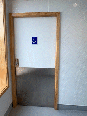 person opening door using CL100 ADA Indicator Lock person opening door using CL100 ADA Indicator Lock