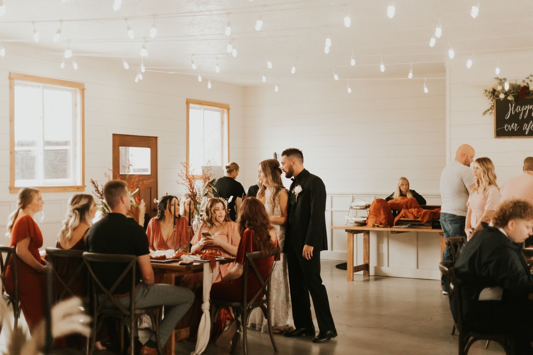 Bride and groom greeting guests at an indoor reception