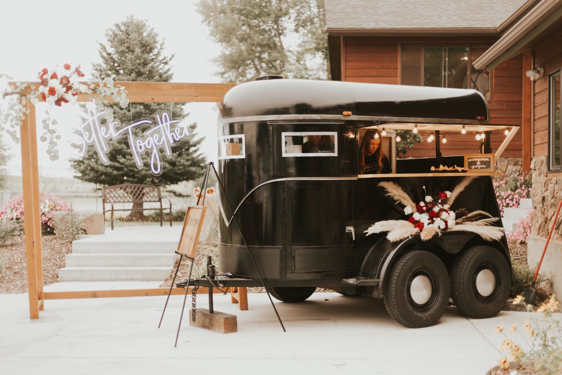 Vintage horse trailer dessert bar with a Better Together neon sign