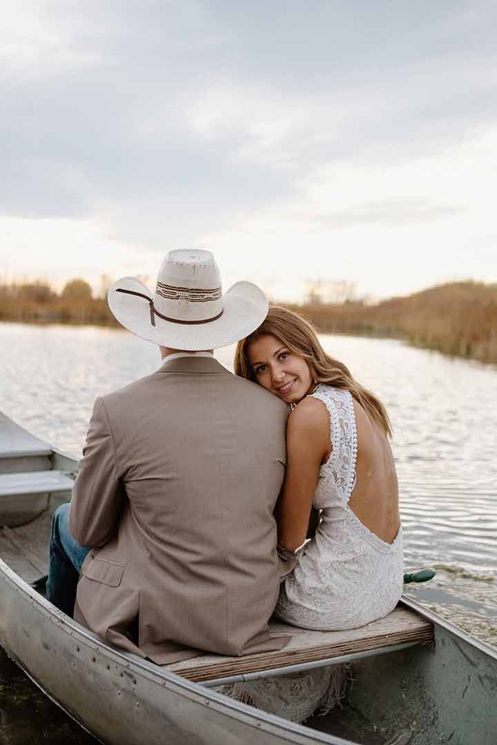 Wedding couple in a rowboat on the pond
