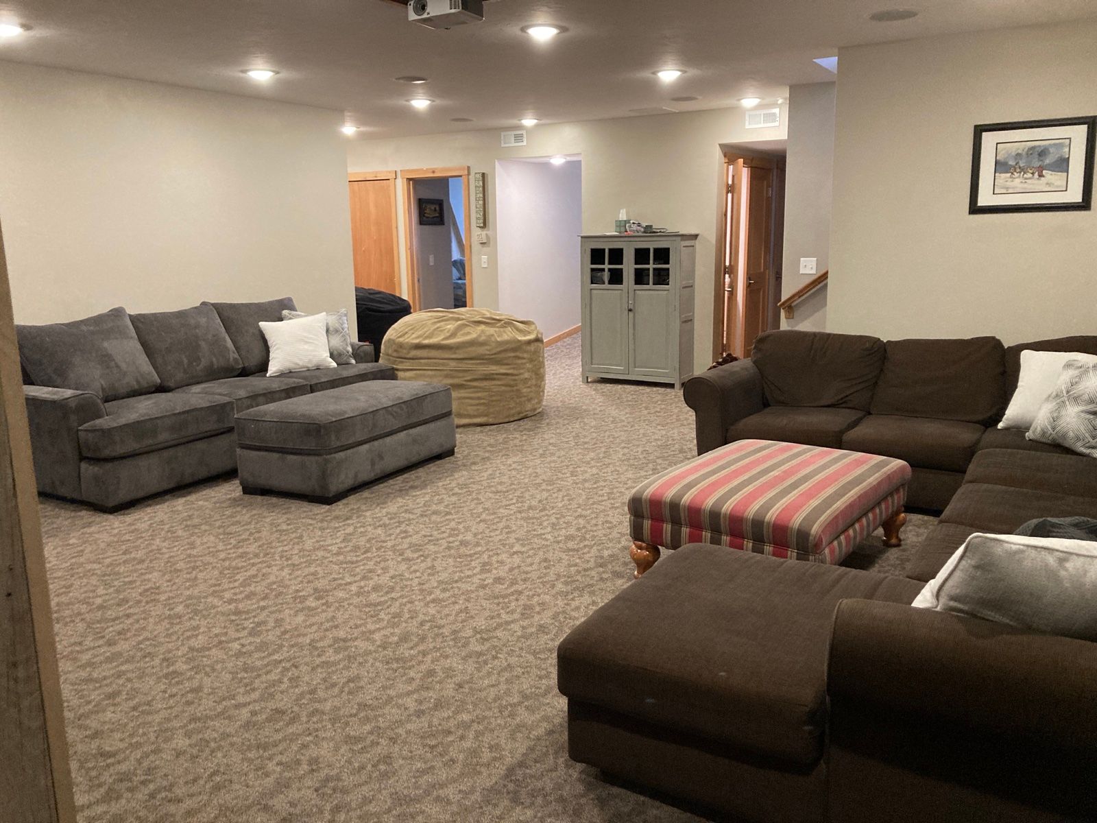 Media lounge with sectionals and a ceiling projector