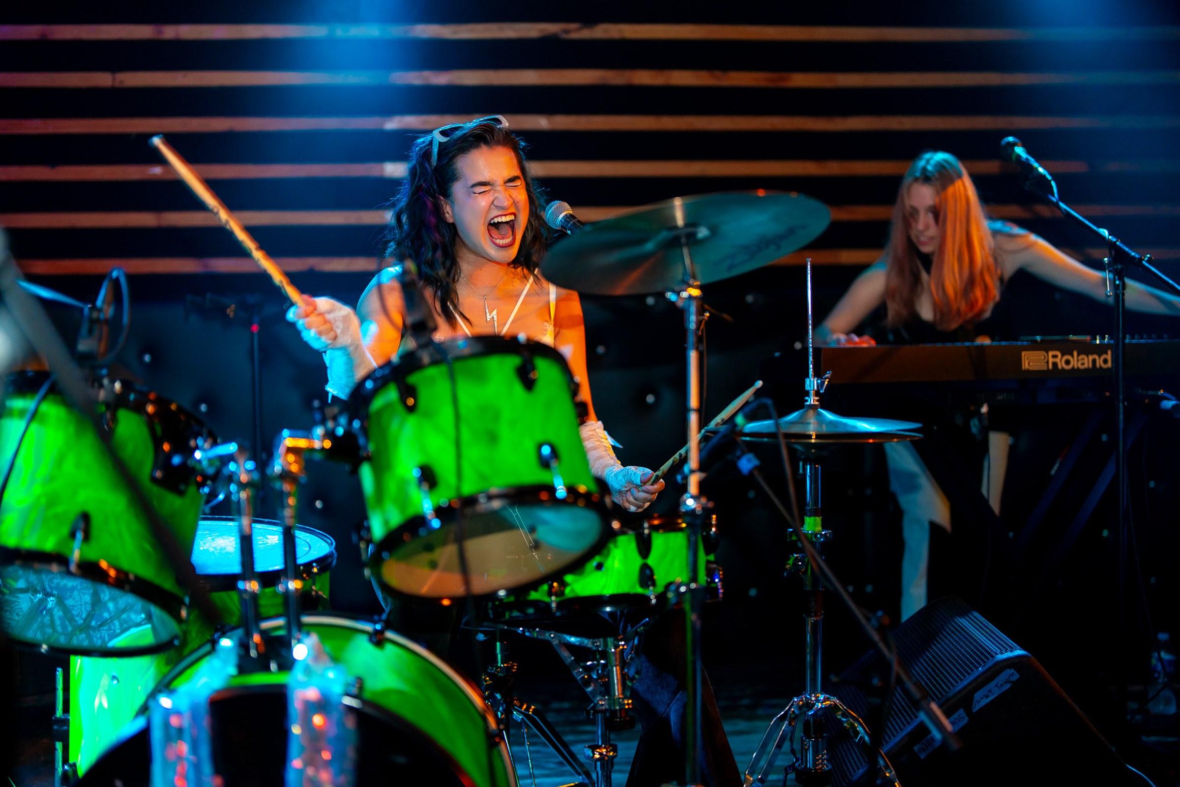 Prismia with her green drum kit