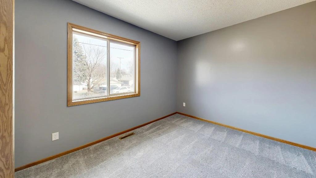 Light grey carpet with visible vacuum tracks in a clean room