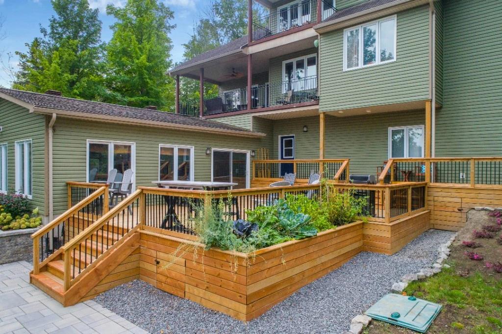 Clean multi-level wood deck and siding after pressure washing in North Vancouver