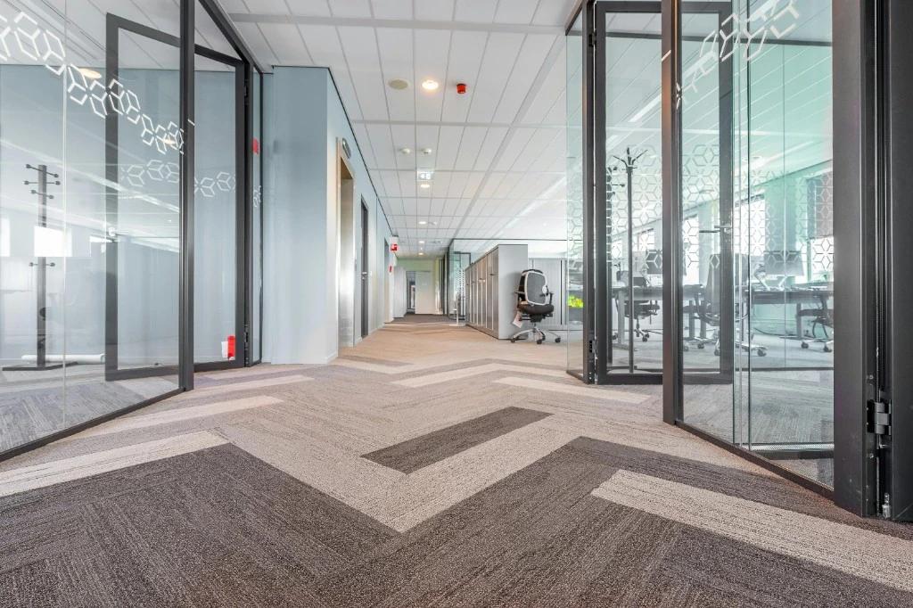 Commercial office carpet with geometric pattern after maintenance cleaning