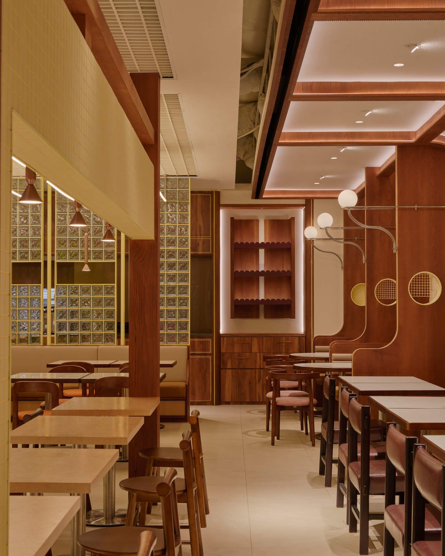 Restaurant interior overview with warm timber shelving, globe pendant lights and row dining along timber counter, Tiong Bahru Chicken Rice at Takashimaya Singapore by LAANK