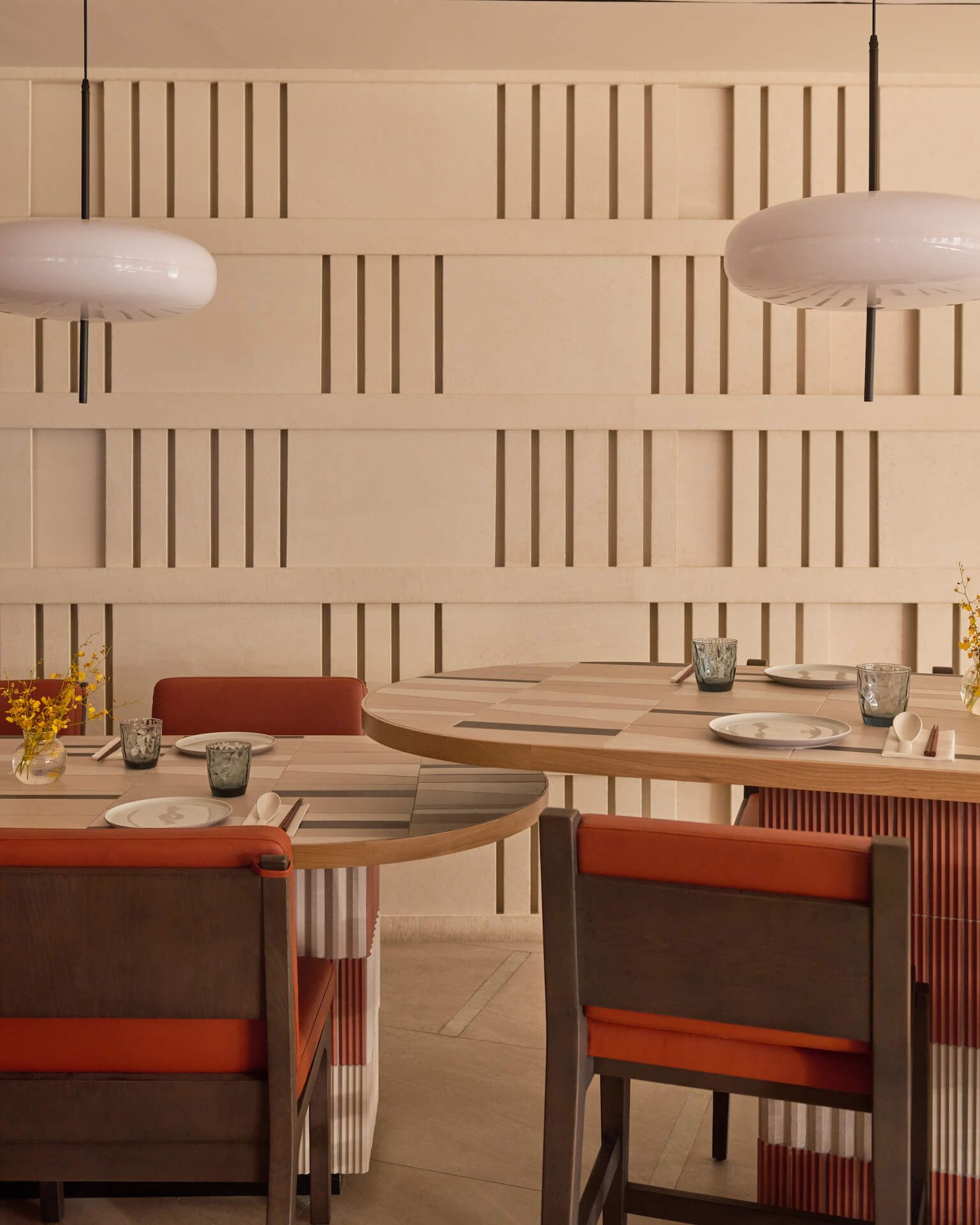 Cosy corner interior with timber batten screens, hanging creeper plants and disc pendant lights, Chatterbox Cafe at Resorts World Sentosa Singapore by LAANK