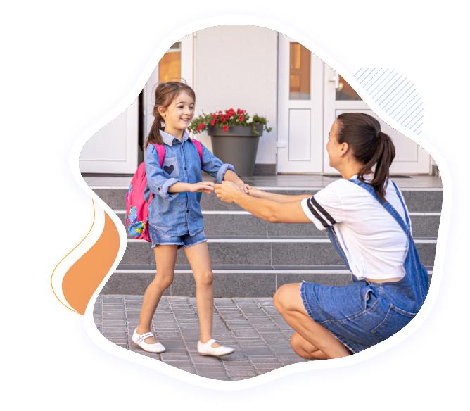 Child arriving happily at First Foundation Preschool, greeted by parent during drop-off