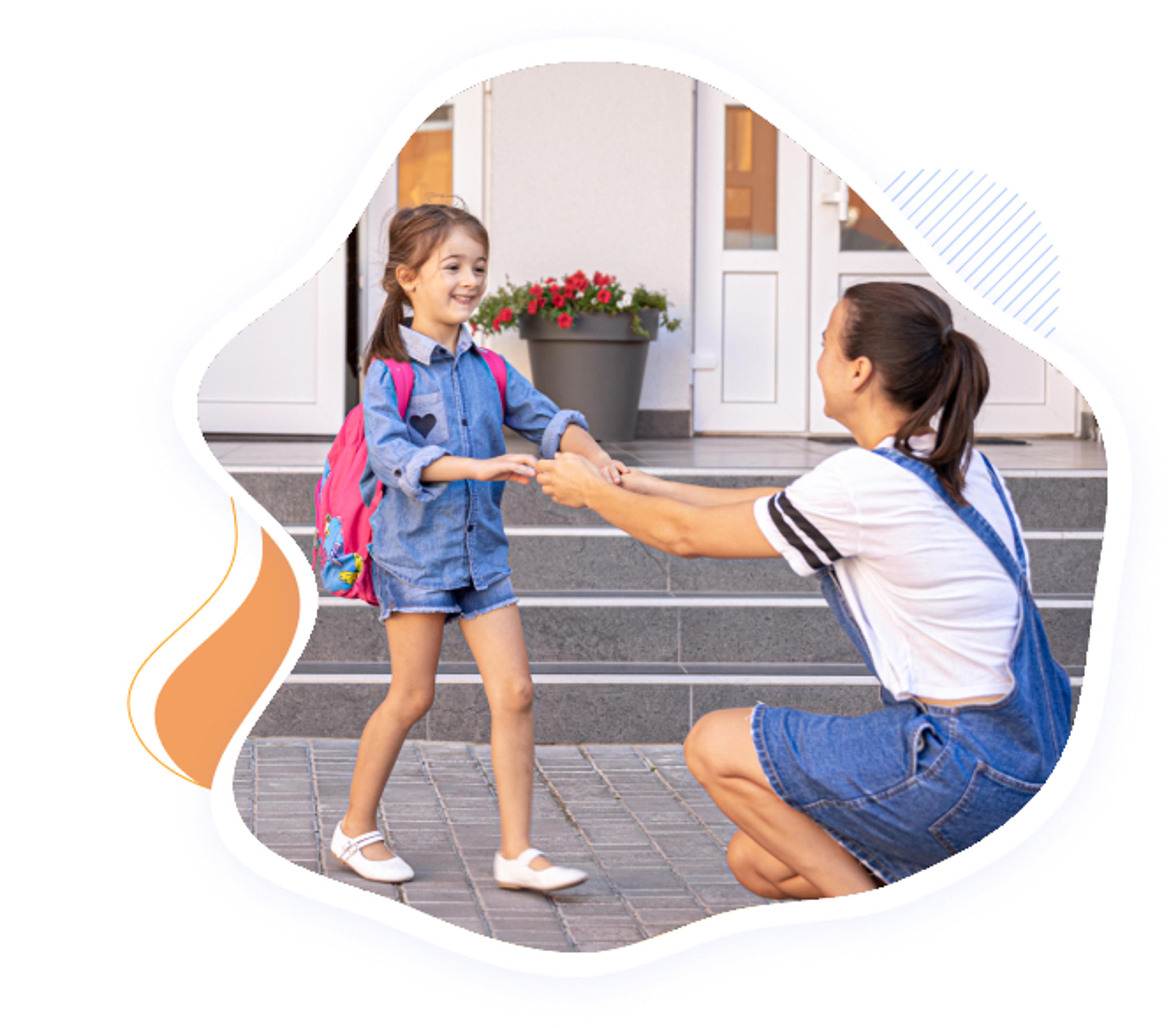 Child arriving happily at First Foundation Preschool, greeted by parent during drop-off