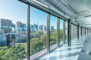 DSDHA's The Hickman view of the Sixth Floor, with large glass windows looking north west toward The City of London skyline