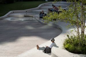 Exchange square during Spring, man chilling barefoot on the steps