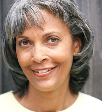 Smiling woman with gray hair and neutral background