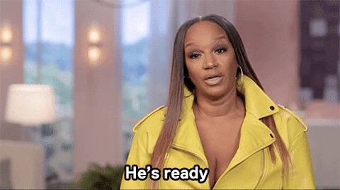 basketball+wives+GIF+by+VH1.gif A woman in a yellow leather jacket speaks emphatically, captioned 'He's ready.'