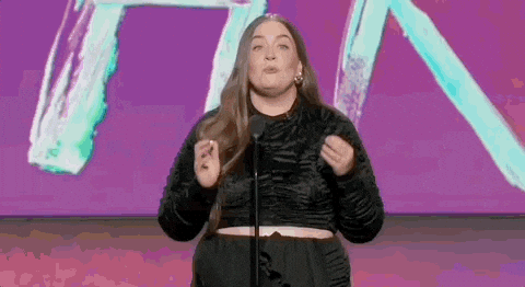 Aidy+Bryant+Regret+GIF+by+Film+Independent+Spirit+Awards+(1).gif A woman on a colorful stage says 'We love it. We do it. We regret it.'