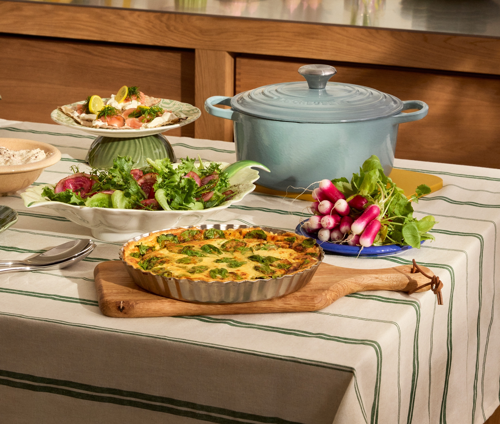 Pääsiäisen ruoat on katettu pöydälle raidalliselle pöytäliinalle