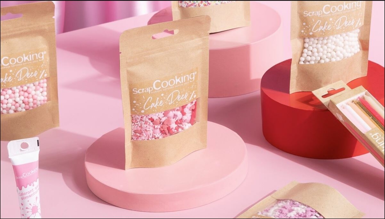 a bunch of bags of sprinkles are sitting on top of a pink table .