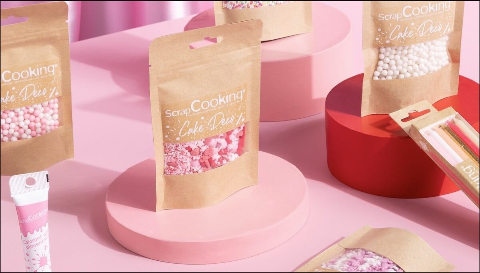 a bunch of bags of sprinkles are sitting on top of a pink table .