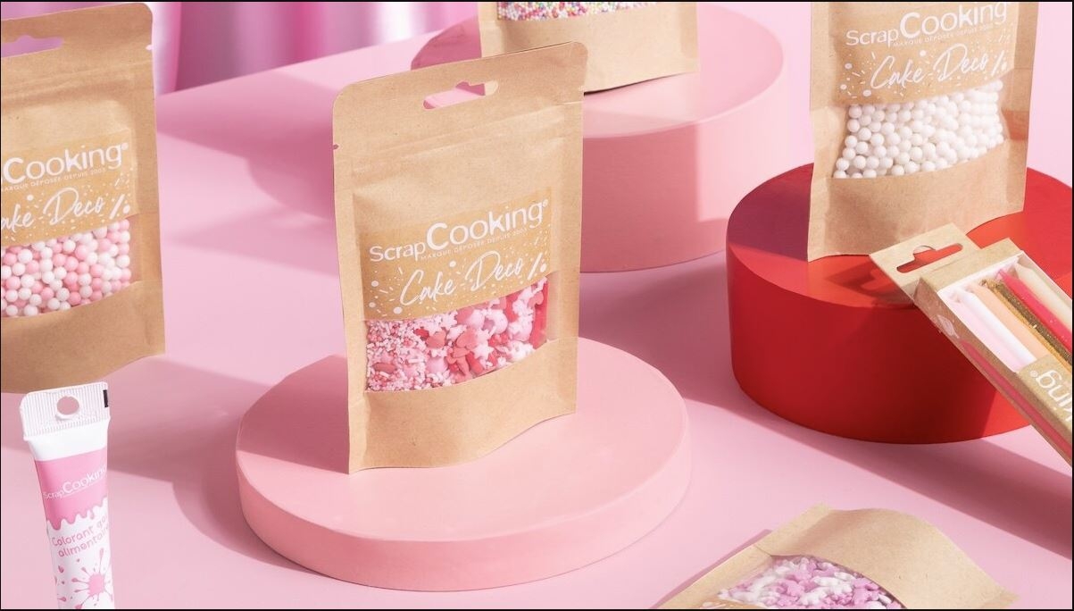 a bunch of bags of sprinkles are sitting on top of a pink table .