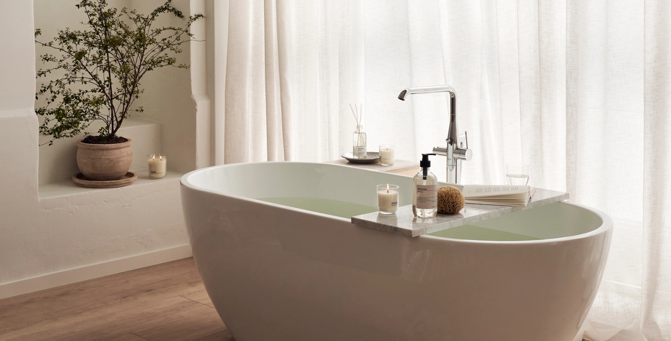 Et badekar på et bad ved siden av et vindu