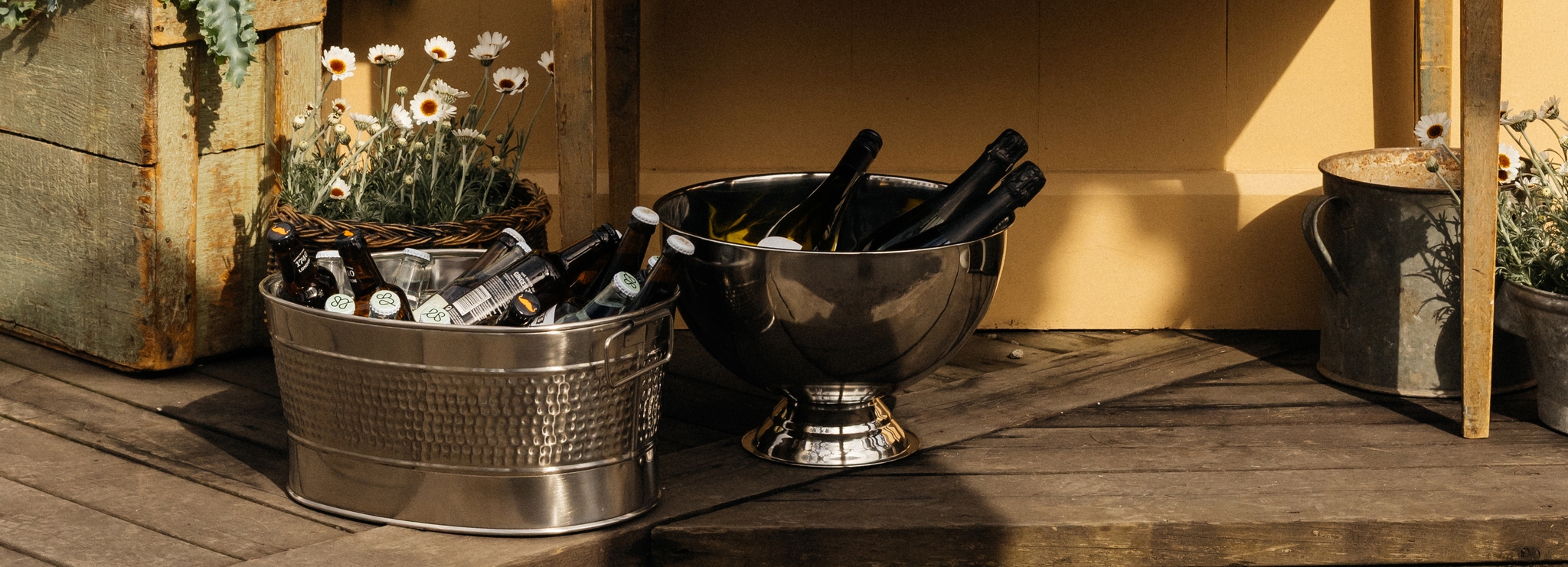 Ölhink med öl och champagnekylare med champagne på en altan utomhus