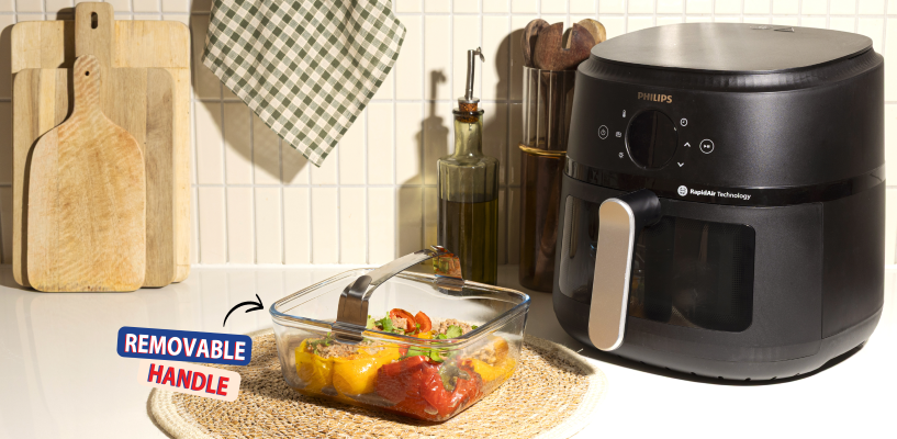 Svart Philips Airfryer med en glassform med avtakbart håndtak på en lys kjøkkenbenk.